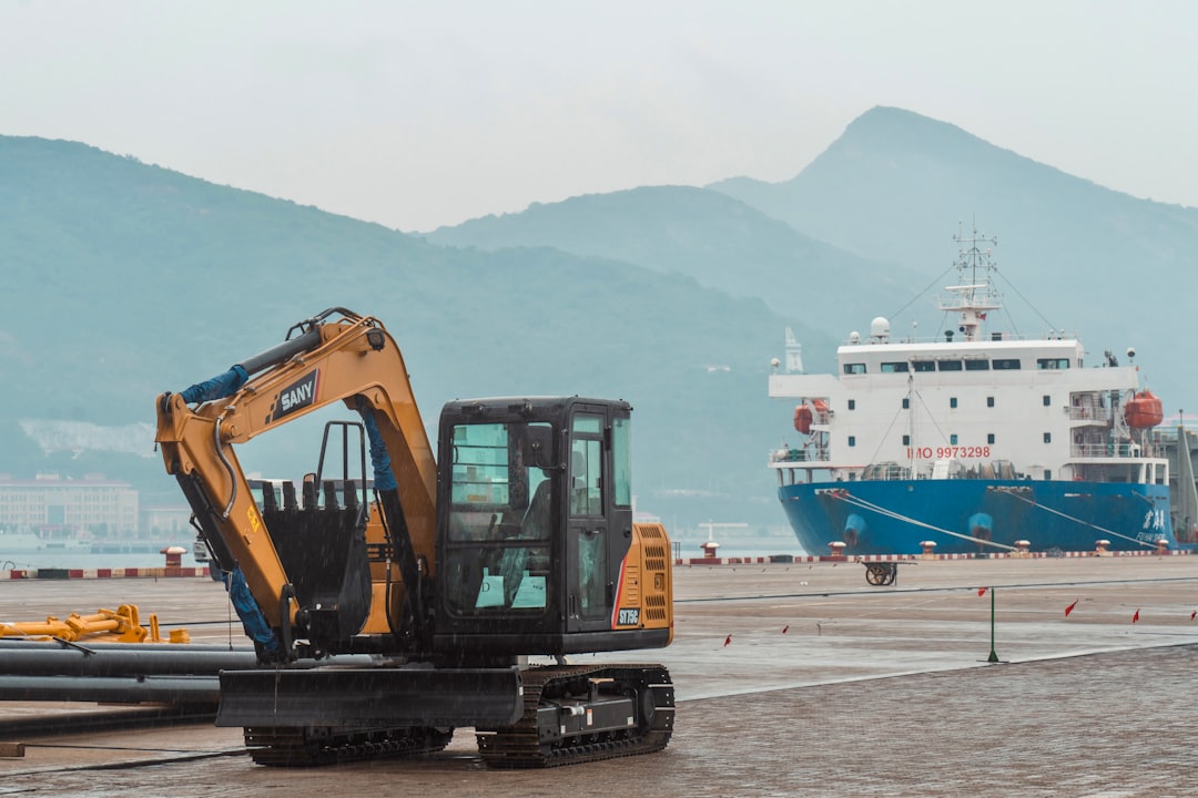 A large boat in the water near a construction site