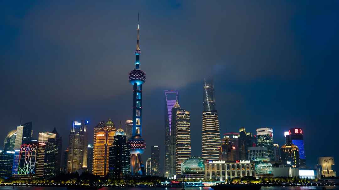 Shanghai skyline illuminated at night.