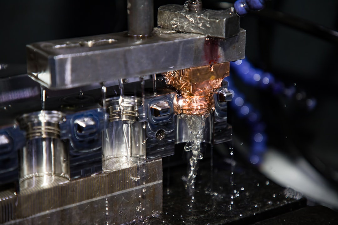 a close up of a machine making a piece of metal