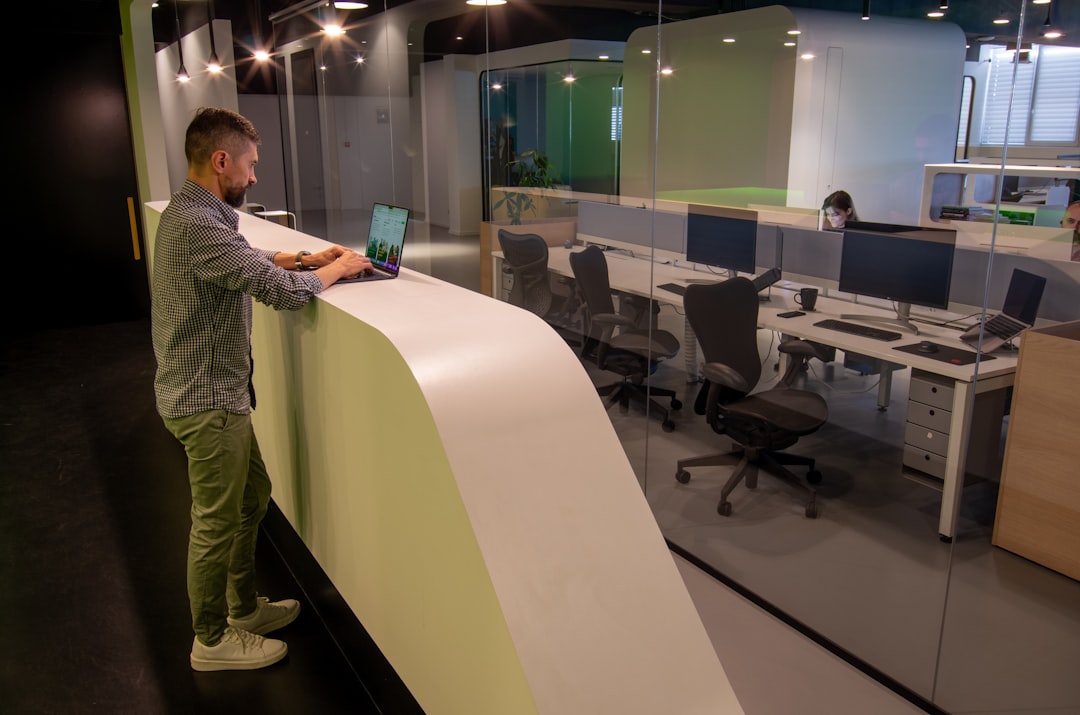 a man standing at a desk in an office