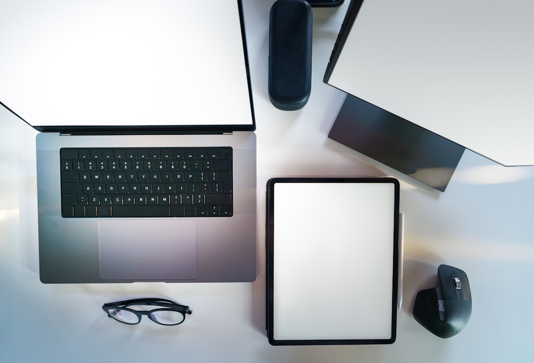 A laptop computer sitting on top of a white desk