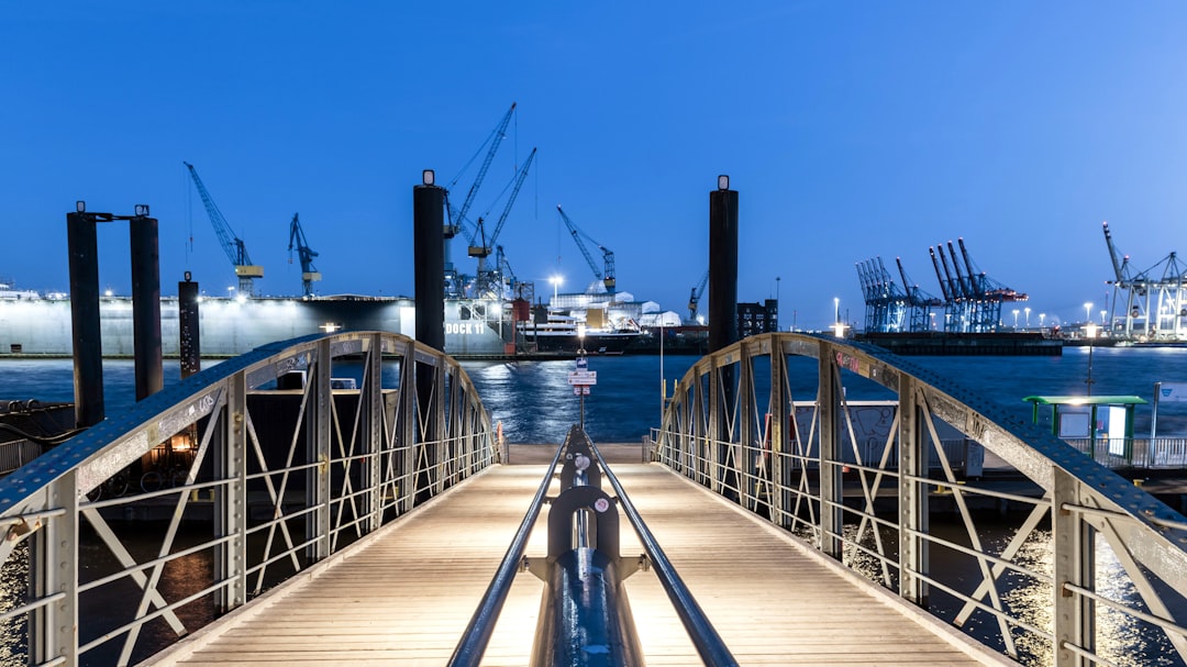 Bridge leads to the harbor at night.