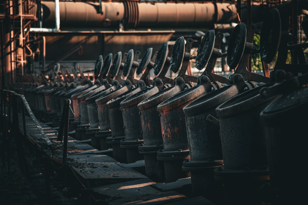 Row of industrial machinery with large metal wheels