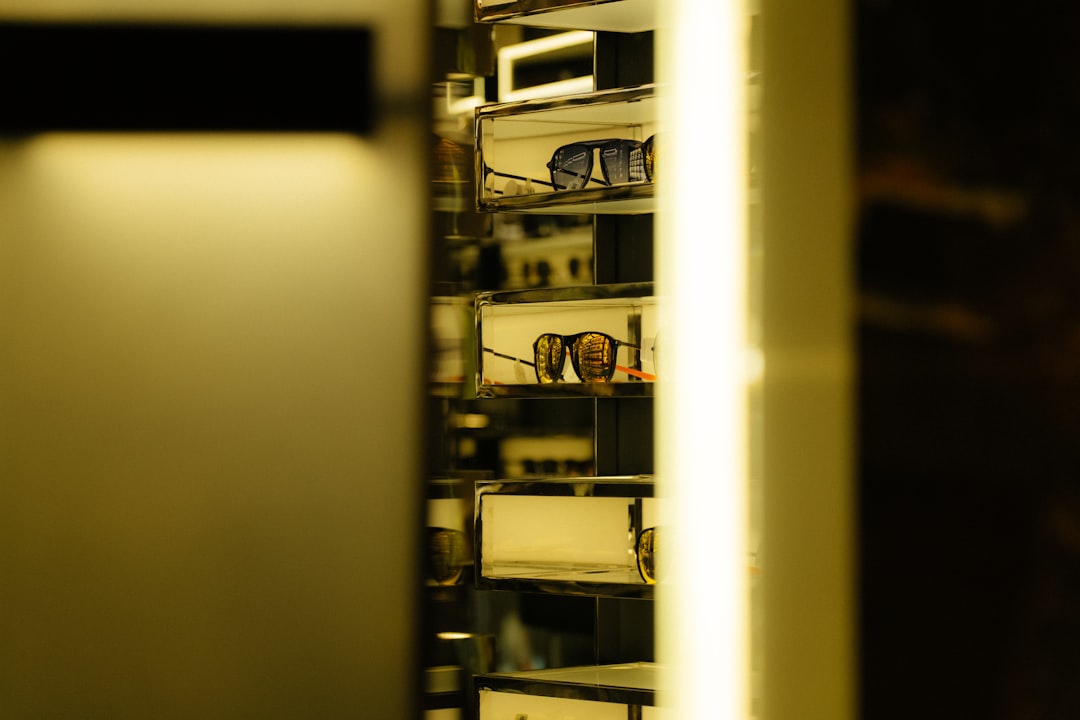Sunglasses displayed on shelves in a store.