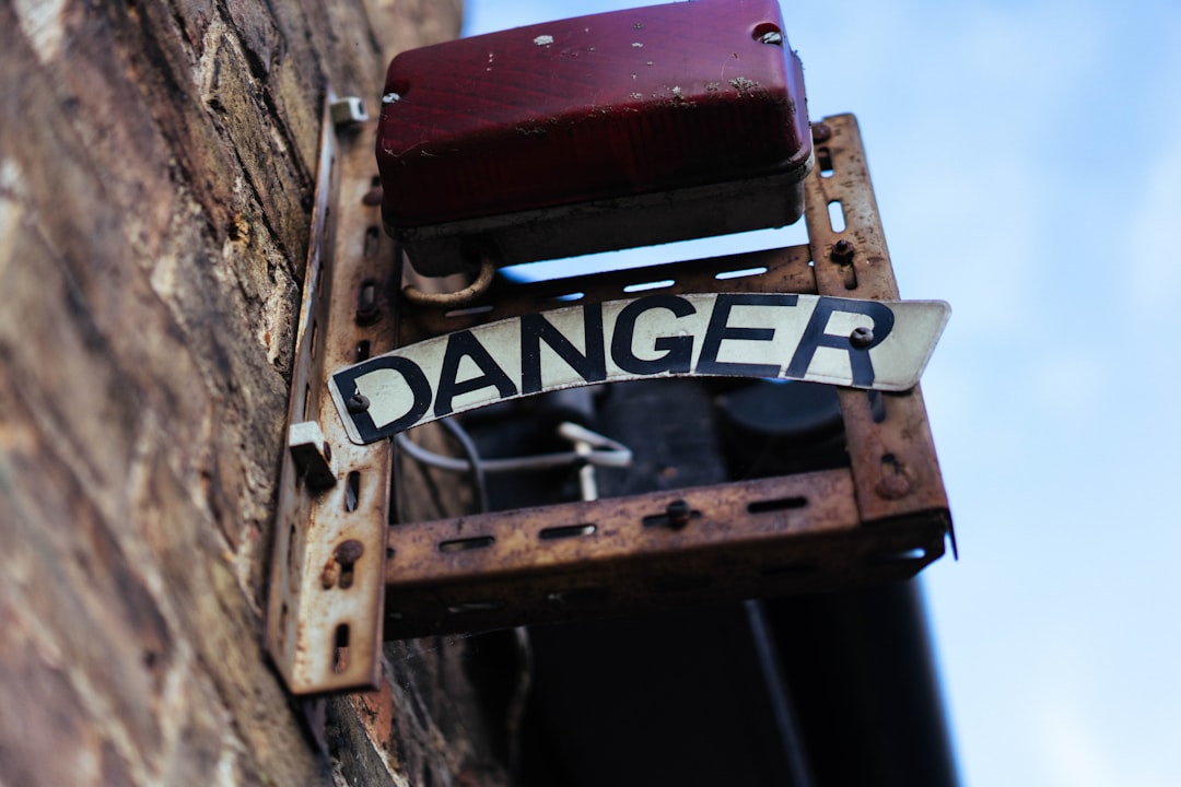 Rusty metal sign with the word danger.
