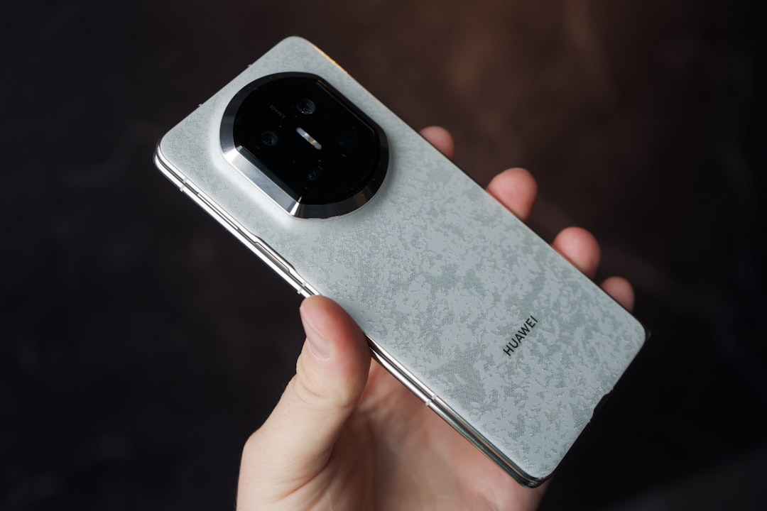 Hand holding a smartphone with a textured back