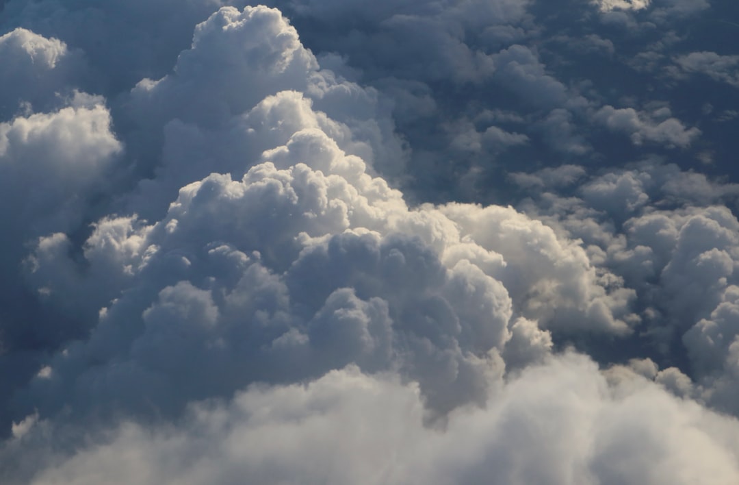Fluffy white clouds against a dark sky.