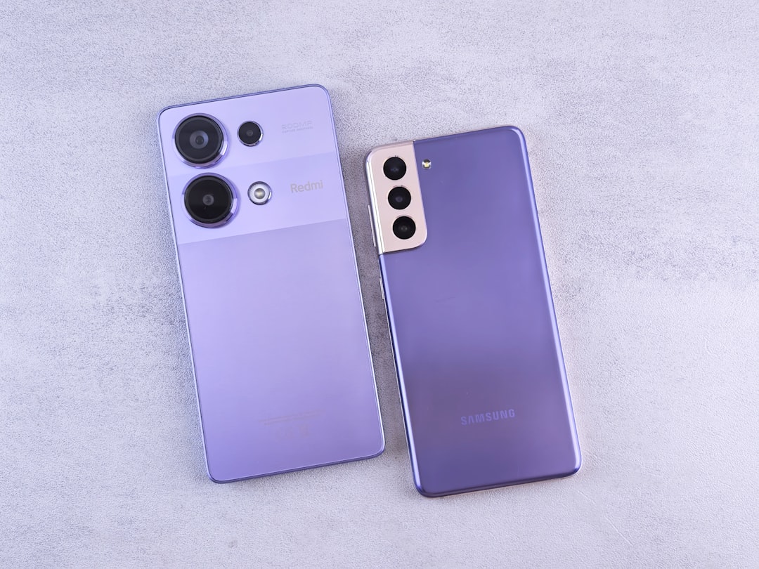 Two purple cell phones sitting next to each other