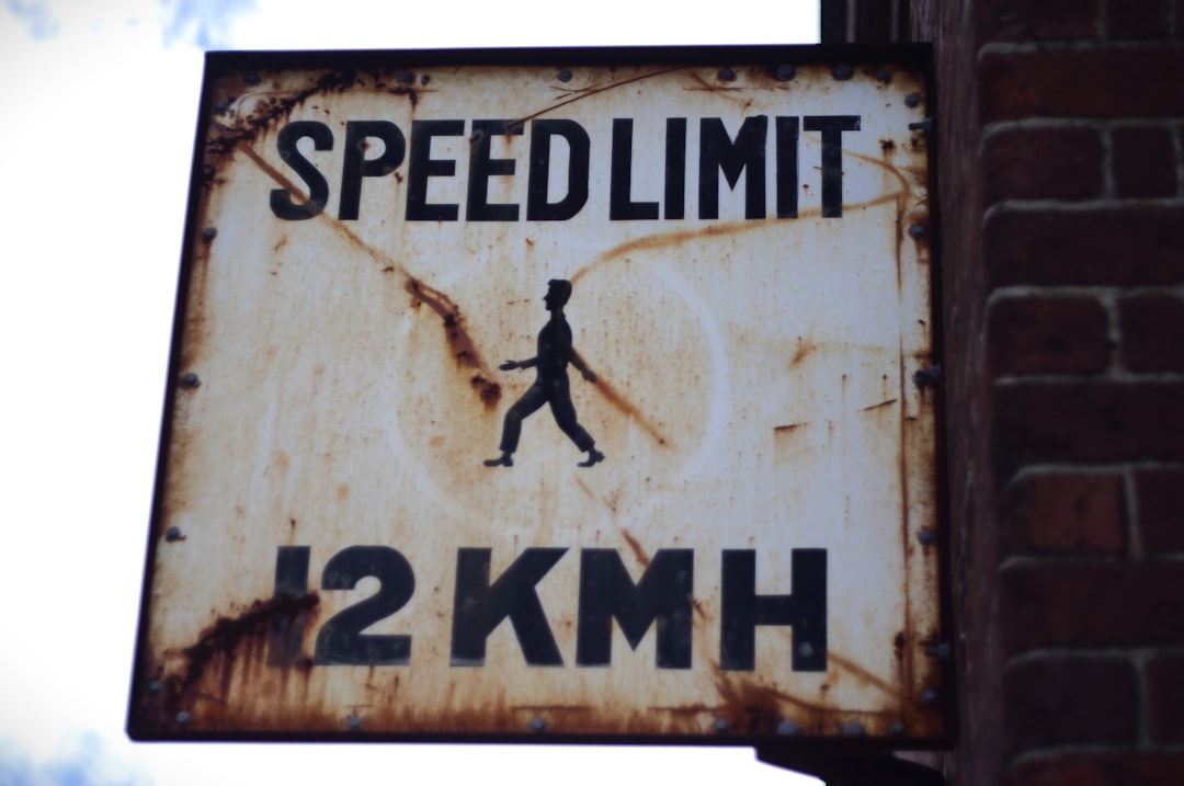 A rusted sign that says speed limit on it