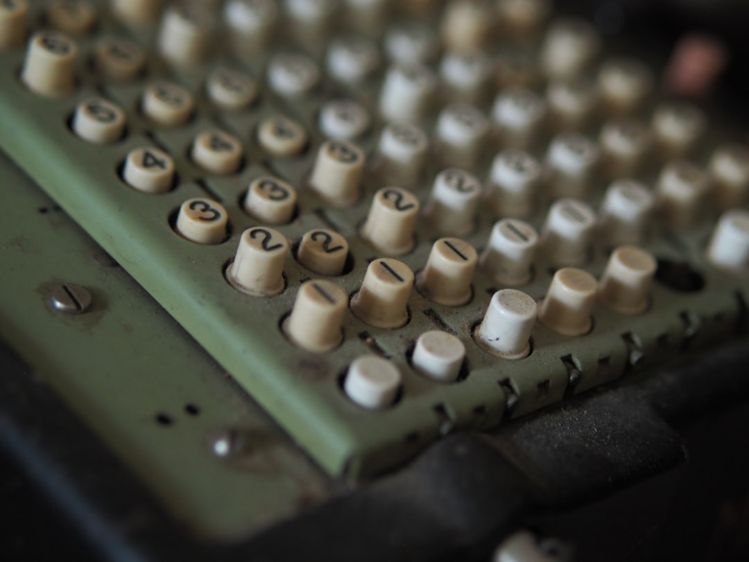 Close-up of an old calculator keyboard with numbered keys.