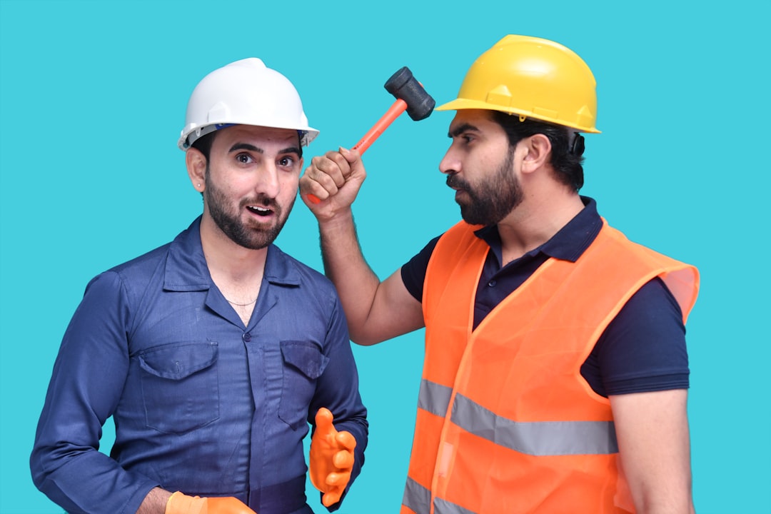 a couple of men wearing hard hats