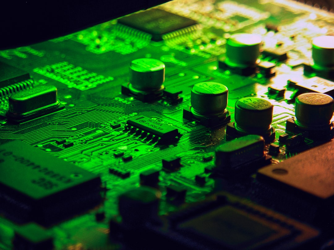 Close-up of a green circuit board with electronic components.
