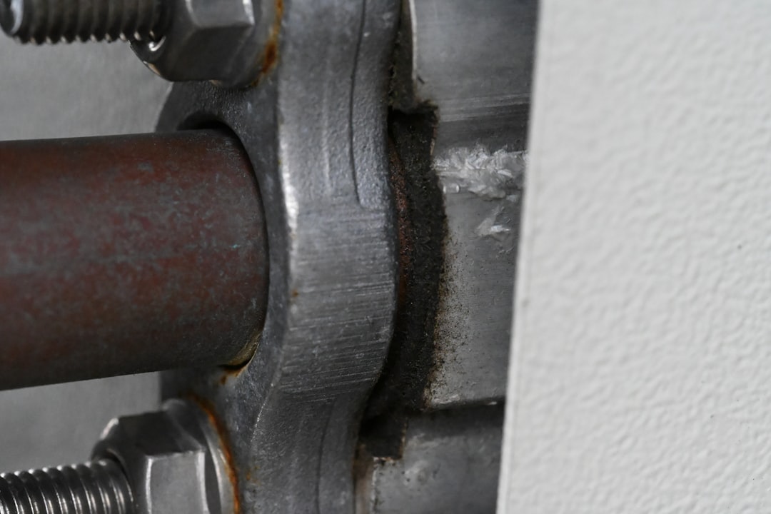 Close up of metal pipe connection with bolts
