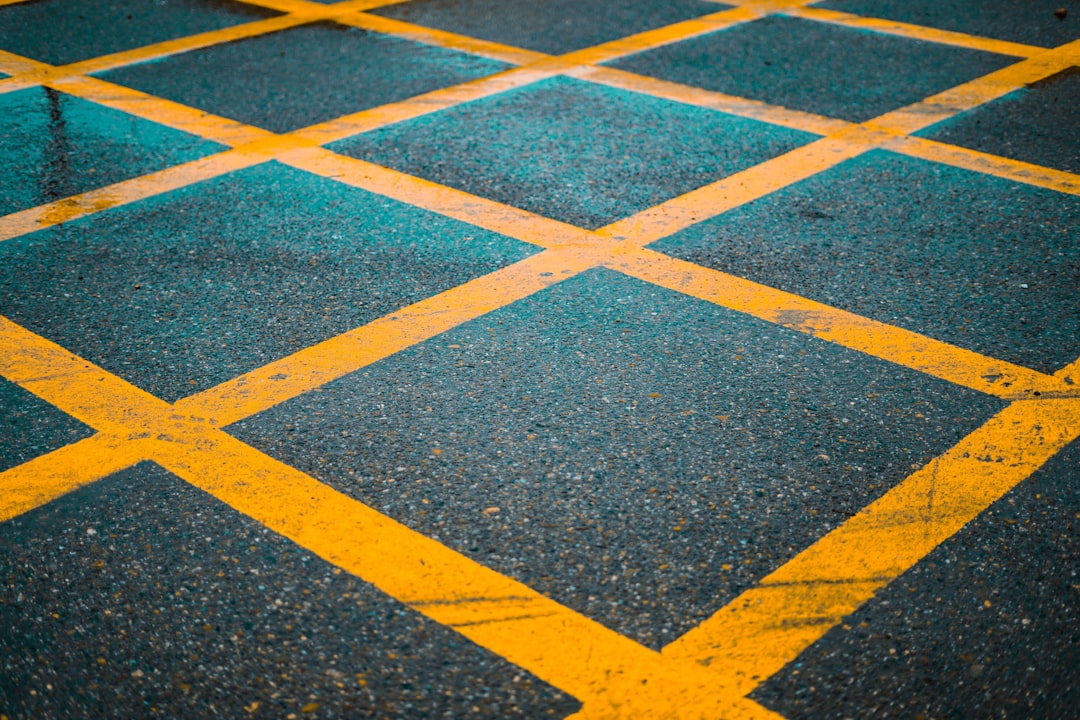 Yellow diamond markings on asphalt road