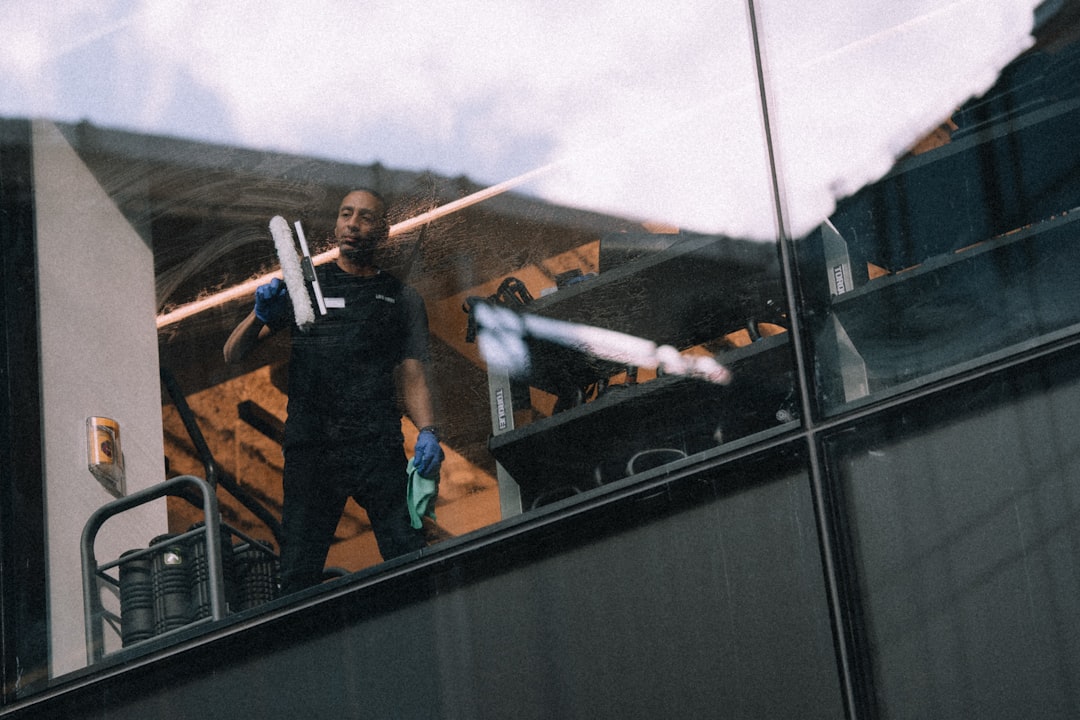 A man cleaning windows on a tall building